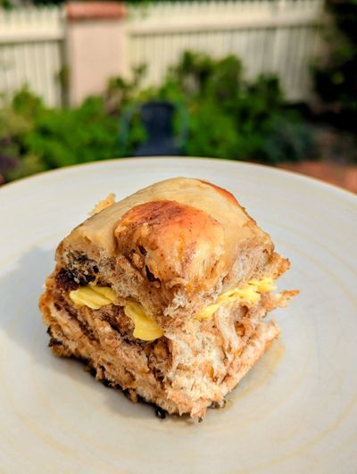 mouth wateringly delicious hot cross bun on a plate